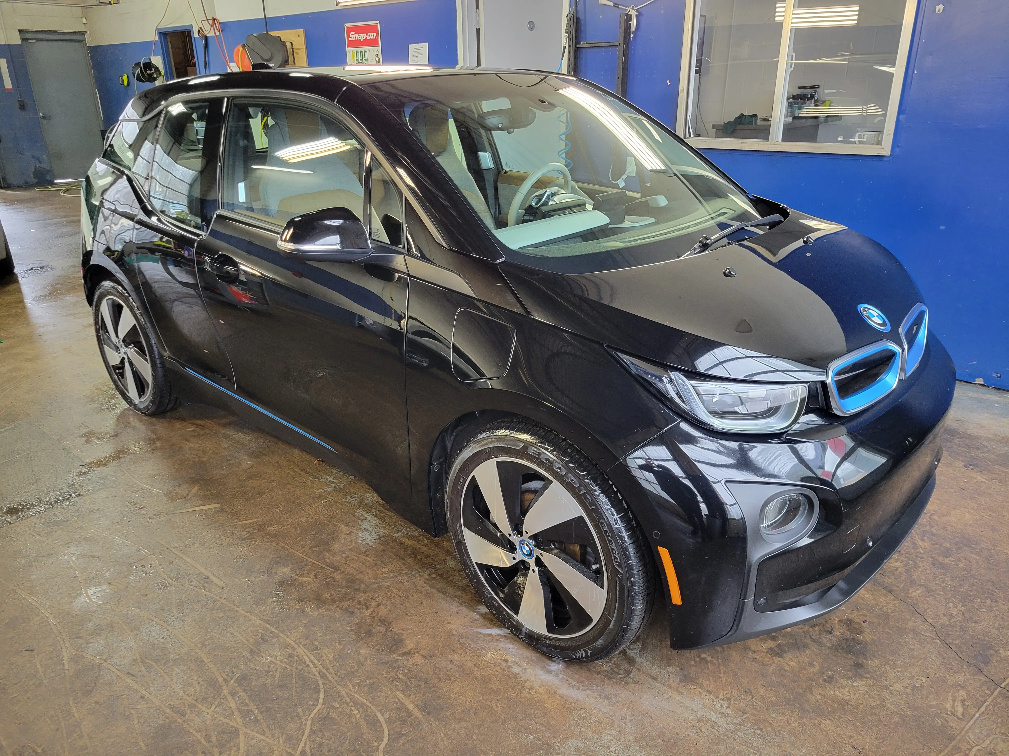 A detailed BMW i3 inside the Fast Track Detailing Solutions shop in Oakland County, Michigan