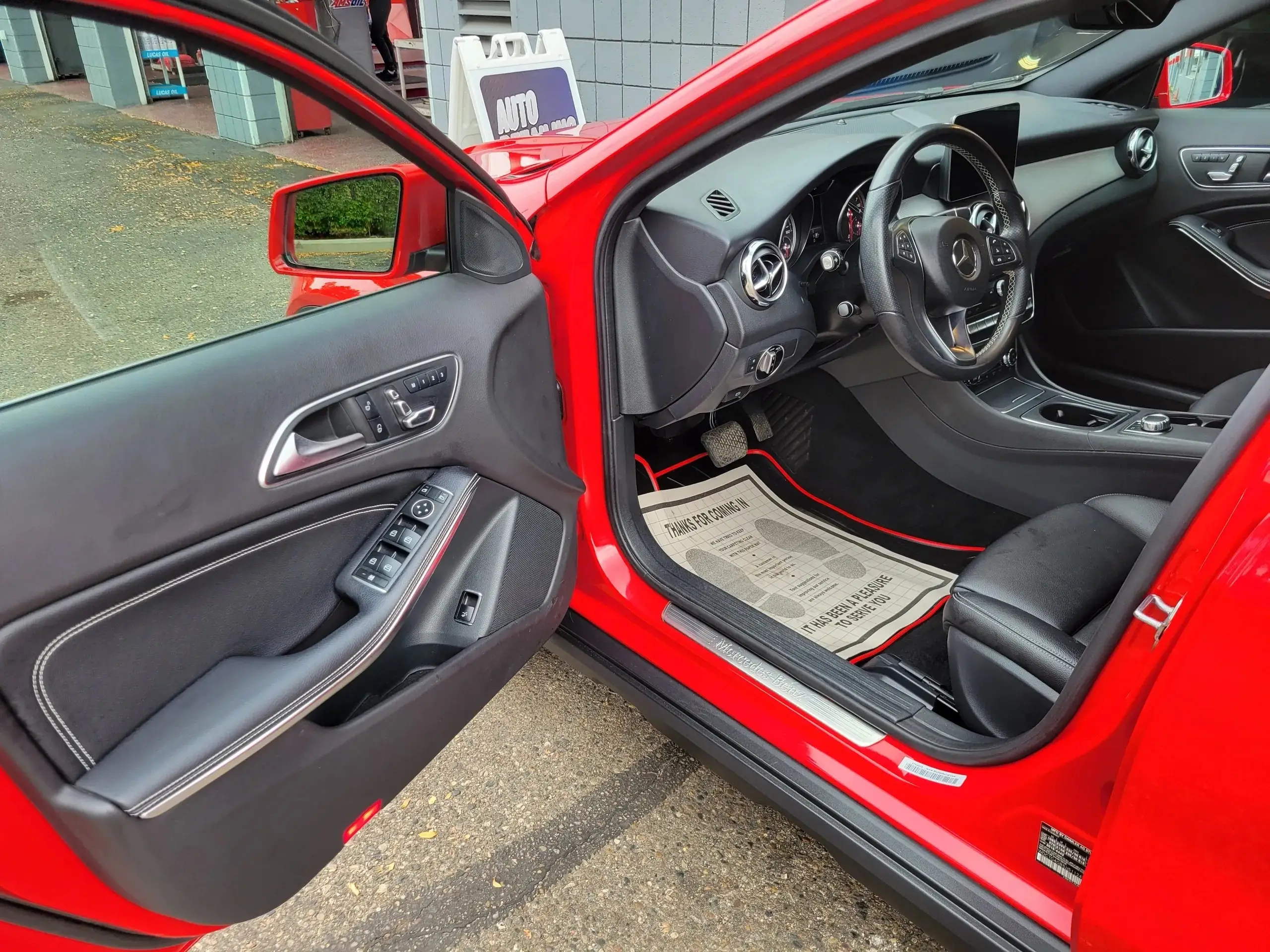 The interior of a red Mercedes after interior detailing