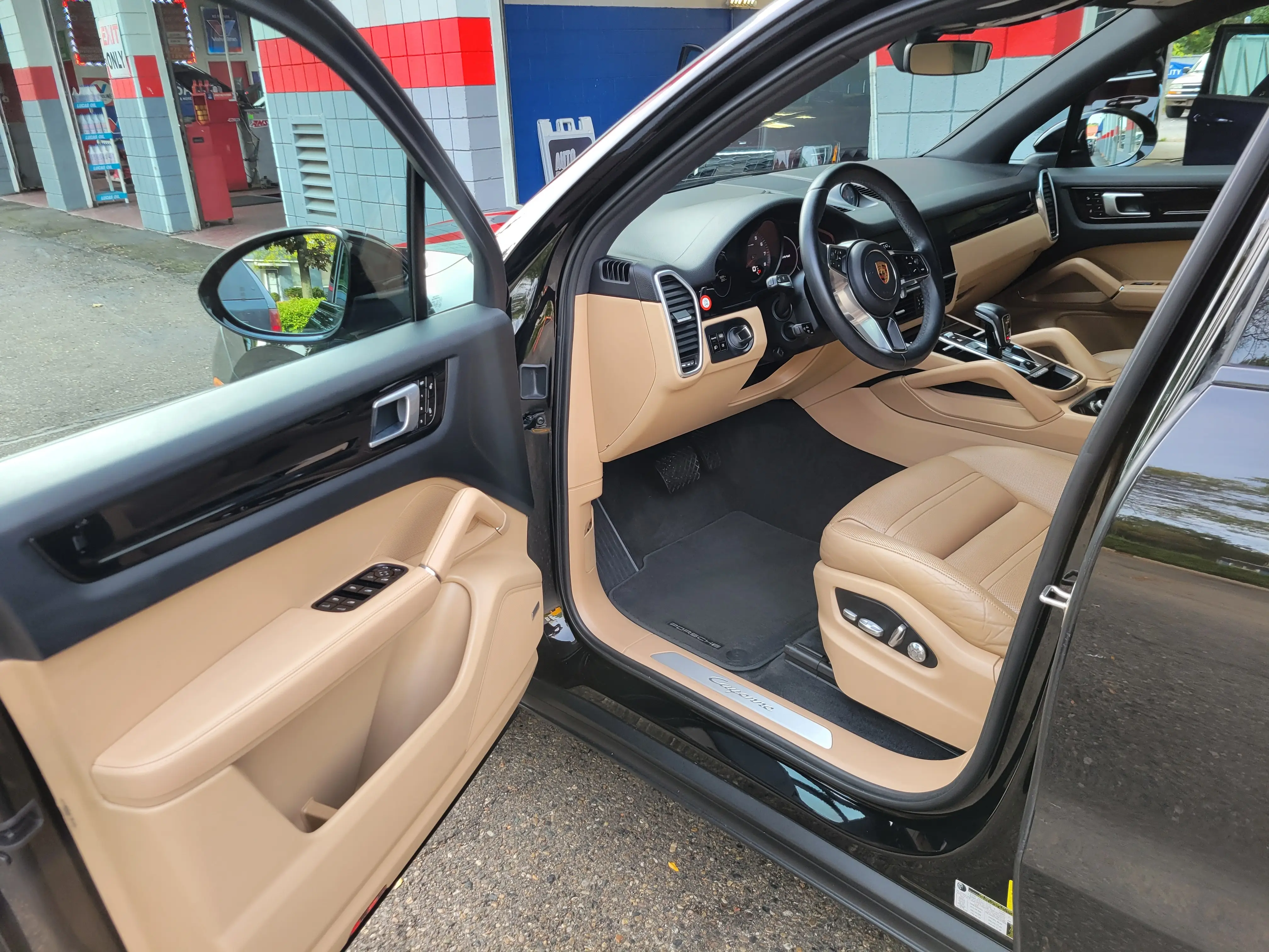 The tan leather interior of a Porsche Cayenne after interior detailing